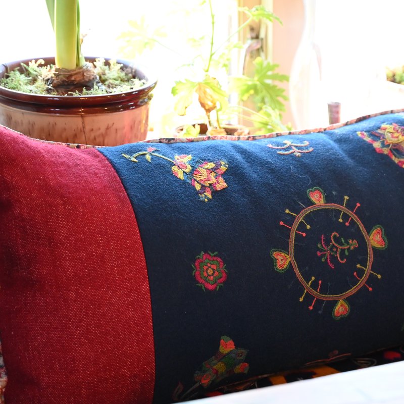 A cushion with traditional rosesaum embroidery