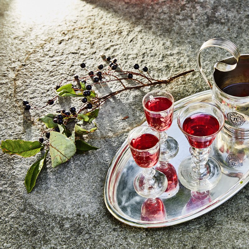 Home-made berry liqueur served on a silver tray